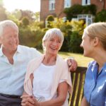 a couple with a caregiver in residential care home
